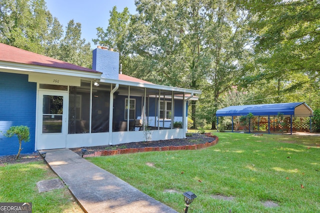 766 Blanton Blvd, Macon, GA 31210 - view of grassy yard with a sunroom and a carport