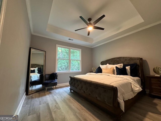 4867 Pinnacle Dr, Stone Mountain, GA 30088 - bedroom featuring a raised ceiling, wood finished floors, baseboards, ornamental molding, and a ceiling fan