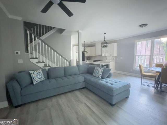 4867 Pinnacle Dr, Stone Mountain, GA 30088 - living room with baseboards, light wood-style floors, ceiling fan, and stairs