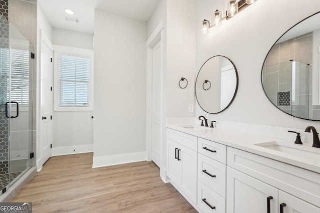 1253 Cumberland Valley Rd, Gainesville, GA 30501 - full bathroom with a stall shower, double vanity, wood finished floors, baseboards, and recessed lighting