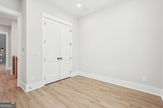 1253 Cumberland Valley Rd, Gainesville, GA 30501 - unfurnished bedroom with light wood finished floors, baseboards, a closet, and recessed lighting