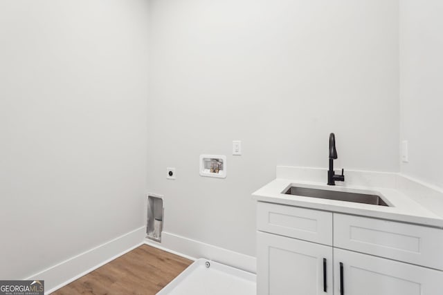1253 Cumberland Valley Rd, Gainesville, GA 30501 - laundry room with washer hookup, cabinet space, electric dryer hookup, wood finished floors, and baseboards