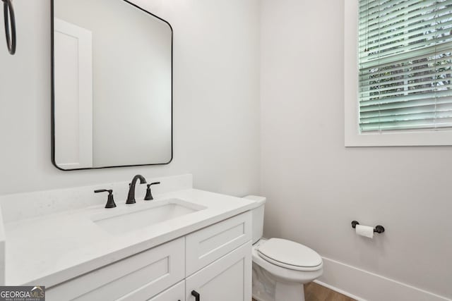 1253 Cumberland Valley Rd, Gainesville, GA 30501 - half bathroom with vanity, toilet, and wood finished floors