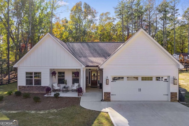 728 Harmony Rd, Temple, GA 30179 - view of front of house featuring stone siding, an attached garage, driveway, a shingled roof, and board and batten siding