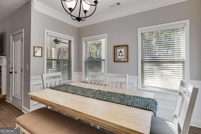 728 Harmony Rd, Temple, GA 30179 - dining area with a chandelier, crown molding, a decorative wall, wainscoting, and dark wood finished floors