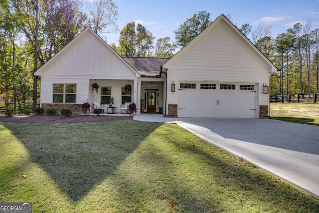 728 Harmony Rd, Temple, GA 30179 - view of front facade featuring stone siding, a garage, concrete driveway, and board and batten siding