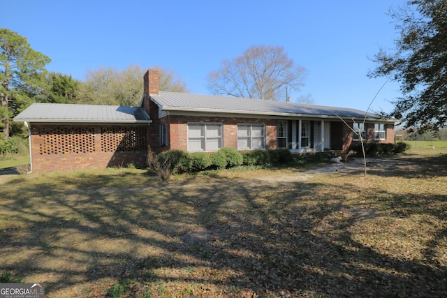 1116 David Newton Rd, Norman Park, GA 31771 - back of property with a chimney, brick siding, metal roof, and a lawn