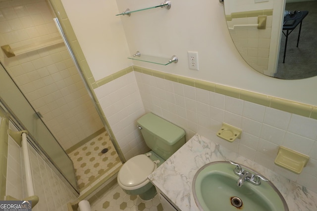 1116 David Newton Rd, Norman Park, GA 31771 - bathroom with a shower stall, tile walls, toilet, a wainscoted wall, and vanity