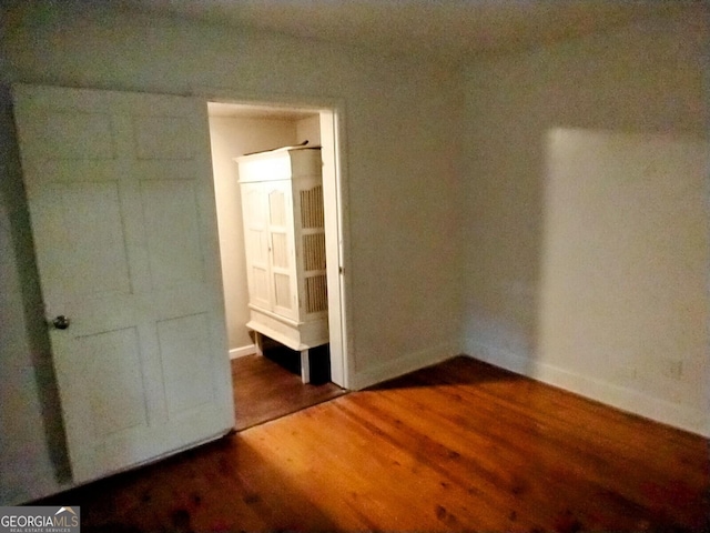 302 Morningside Dr, Clarkesville, GA 30523 - unfurnished bedroom featuring wood finished floors and baseboards