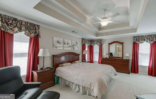 1008 Post Horn Run, Lawrenceville, GA 30045 - carpeted bedroom featuring a tray ceiling, multiple windows, ornamental molding, and ceiling fan
