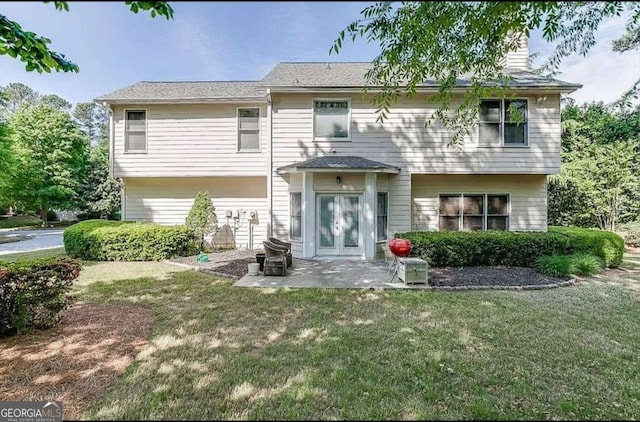 1008 Post Horn Run, Lawrenceville, GA 30045 - back of house featuring a lawn and a patio area