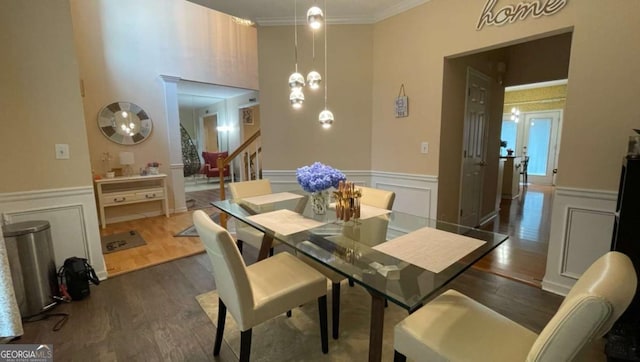 1008 Post Horn Run, Lawrenceville, GA 30045 - dining space featuring wood finished floors, a wainscoted wall, a decorative wall, and ornamental molding
