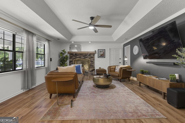 107 Rose Dhu Way, Savannah, GA 31419 - living area with a raised ceiling, ceiling fan, wood finished floors, and a fireplace