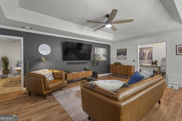 107 Rose Dhu Way, Savannah, GA 31419 - living area featuring a raised ceiling, a ceiling fan, a textured ceiling, light wood-type flooring, and ornamental molding