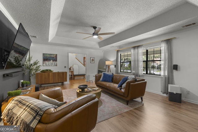 107 Rose Dhu Way, Savannah, GA 31419 - living room with a textured ceiling, stairway, a tray ceiling, wood finished floors, and ceiling fan