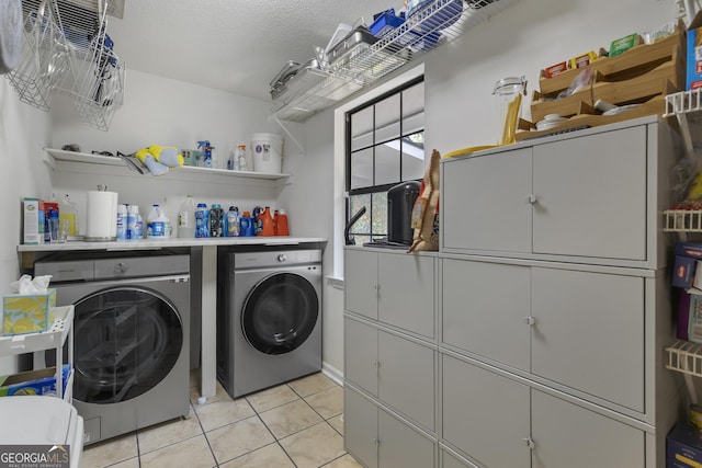 107 Rose Dhu Way, Savannah, GA 31419 - laundry area featuring washing machine and dryer, cabinet space, and light tile patterned flooring