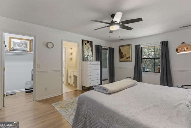 107 Rose Dhu Way, Savannah, GA 31419 - bedroom featuring light wood-type flooring, a spacious closet, a ceiling fan, and connected bathroom