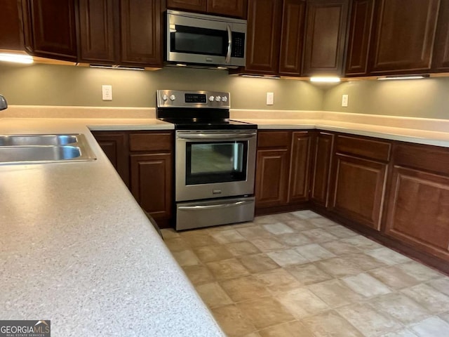 1429 Thyatira Brockton Rd, Jefferson, GA 30549 - kitchen with stainless steel appliances, a sink, light countertops, and dark brown cabinets