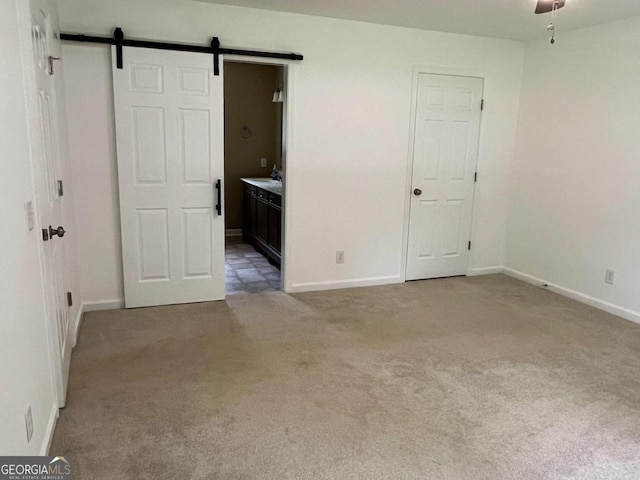 1429 Thyatira Brockton Rd, Jefferson, GA 30549 - empty room featuring carpet floors, a barn door, and baseboards