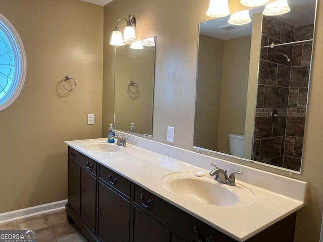 1429 Thyatira Brockton Rd, Jefferson, GA 30549 - full bathroom featuring double vanity, toilet, baseboards, and a tile shower