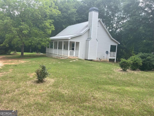 1429 Thyatira Brockton Rd, Jefferson, GA 30549 - view of home's exterior with a lawn, a porch, a chimney, and metal roof