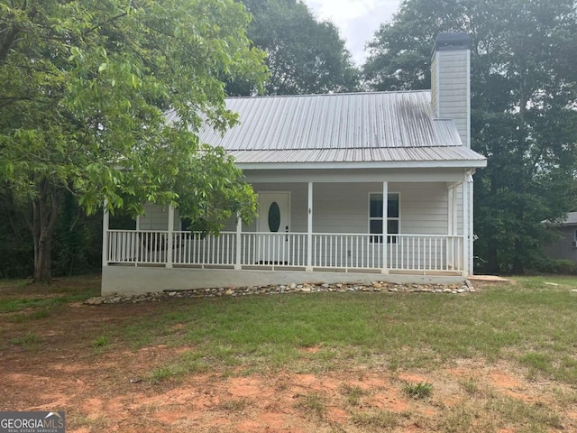 1429 Thyatira Brockton Rd, Jefferson, GA 30549 - view of front of house featuring a porch, a chimney, metal roof, and a front yard