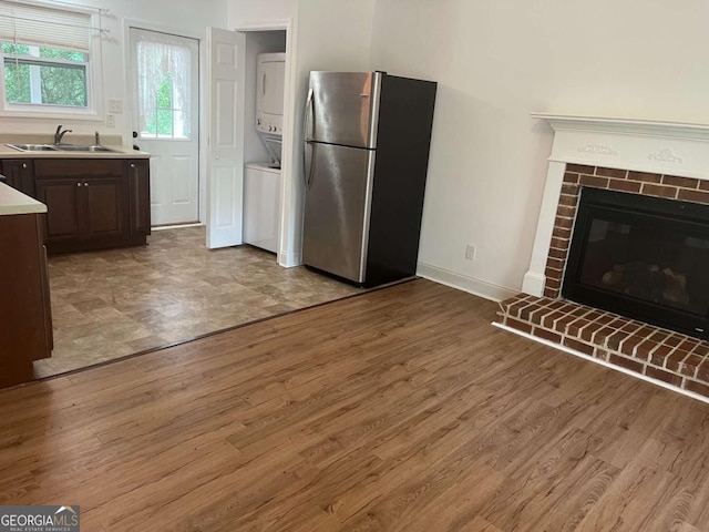 1429 Thyatira Brockton Rd, Jefferson, GA 30549 - kitchen with freestanding refrigerator, stacked washer / dryer, a sink, light countertops, and light wood-style floors