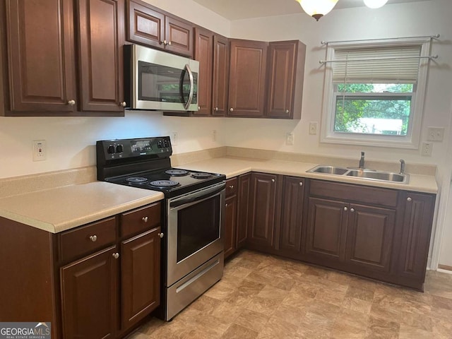 1429 Thyatira Brockton Rd, Jefferson, GA 30549 - kitchen featuring appliances with stainless steel finishes, a sink, light countertops, and dark brown cabinetry