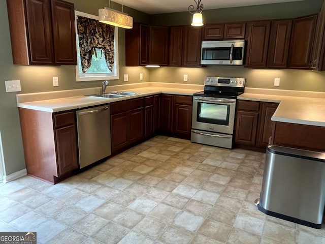 1429 Thyatira Brockton Rd, Jefferson, GA 30549 - kitchen featuring stainless steel appliances, a sink, light countertops, and hanging light fixtures