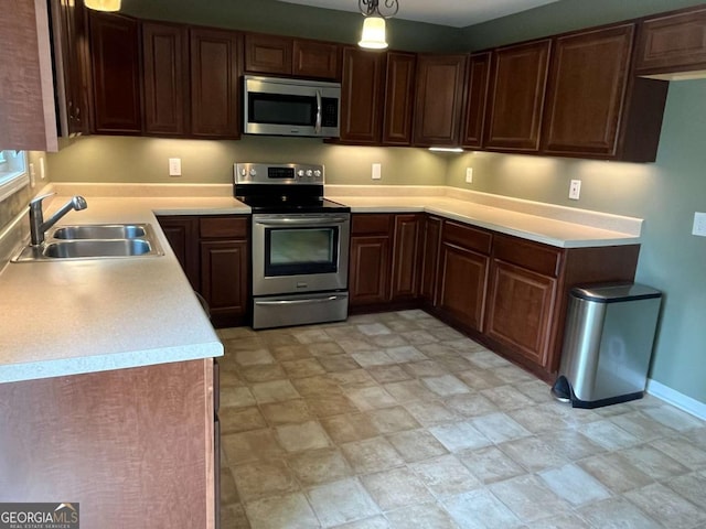 1429 Thyatira Brockton Rd, Jefferson, GA 30549 - kitchen featuring stainless steel appliances, a sink, light countertops, baseboards, and stone finish flooring