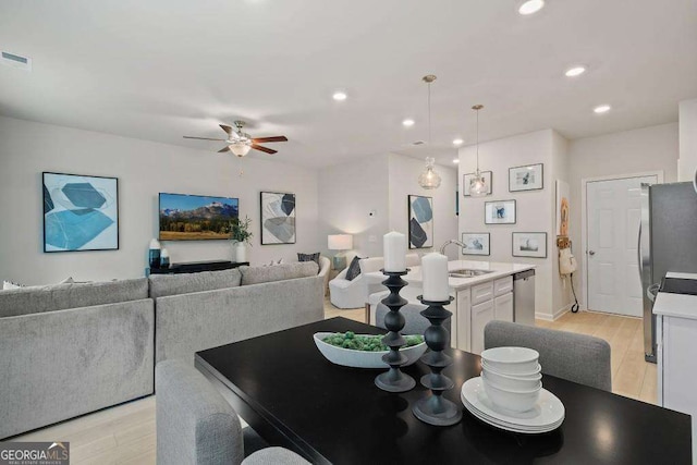 377 Navigator Ln, Mcdonough, GA 30253 - dining space featuring light wood-style flooring, ceiling fan, recessed lighting, and baseboards