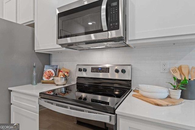 377 Navigator Ln, Mcdonough, GA 30253 - kitchen featuring stainless steel appliances, white cabinetry, decorative backsplash, and light countertops