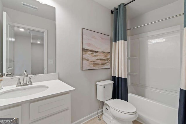 377 Navigator Ln, Mcdonough, GA 30253 - bathroom with toilet, vanity, shower / tub combo with curtain, and baseboards