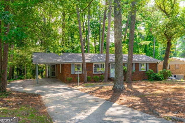 1671 Drayton Woods Dr, Tucker, GA 30084 - ranch-style home with driveway, brick siding, and an attached carport