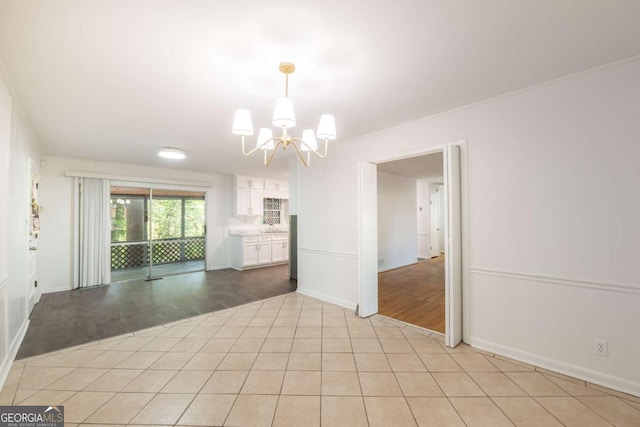 1671 Drayton Woods Dr, Tucker, GA 30084 - empty room with a chandelier, baseboards, light wood-type flooring, and a sink