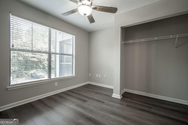 211 N Ave Unit 1122, Athens, GA 30601 - unfurnished bedroom with dark wood-type flooring, a closet, baseboards, and a ceiling fan