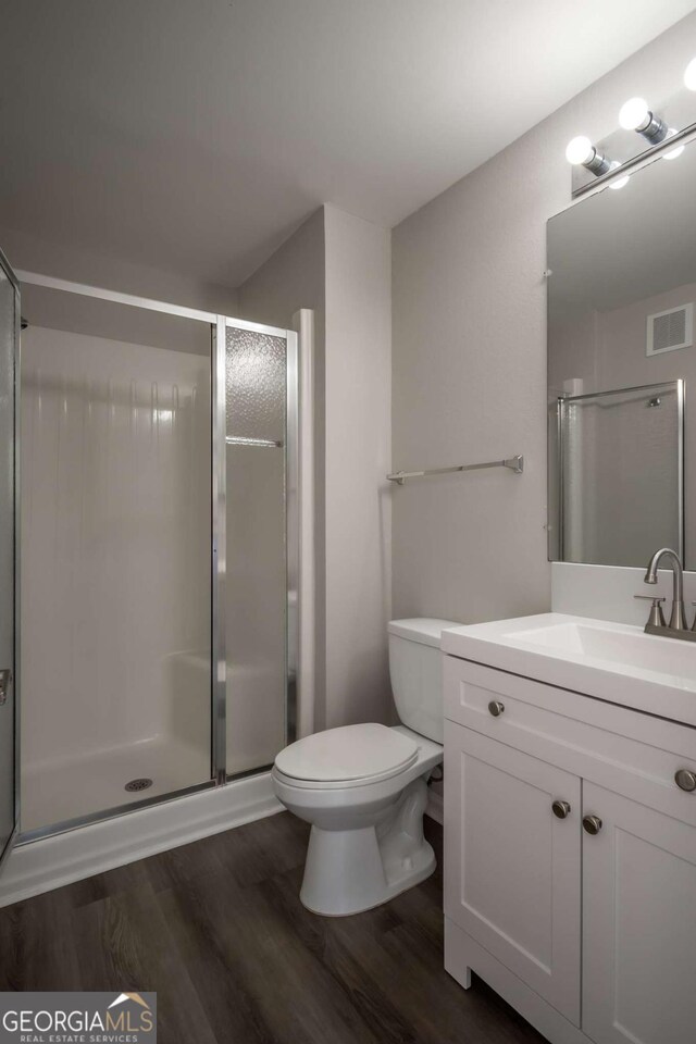 211 N Ave Unit 1122, Athens, GA 30601 - full bath with wood finished floors, toilet, vanity, and a stall shower
