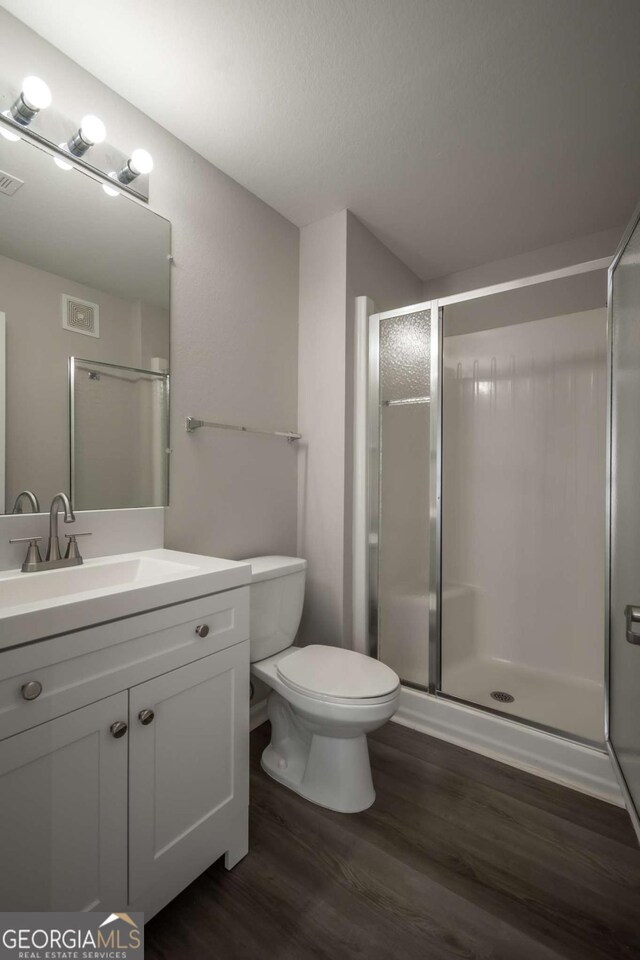 211 N Ave Unit 1122, Athens, GA 30601 - full bath featuring wood finished floors, toilet, vanity, and a stall shower