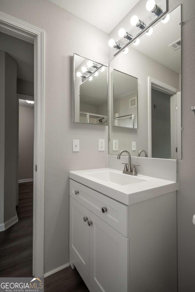 211 N Ave Unit 1122, Athens, GA 30601 - bathroom featuring vanity, wood finished floors, and baseboards
