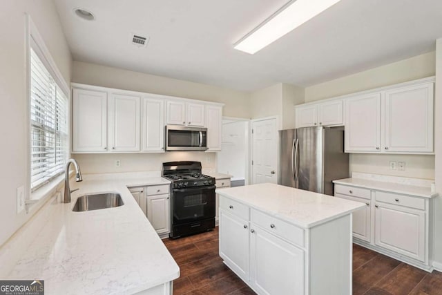 153 Towey Trl, Woodstock, GA 30188 - kitchen featuring stainless steel appliances, a sink, a center island, and white cabinetry