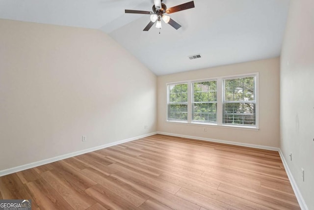 153 Towey Trl, Woodstock, GA 30188 - spare room featuring vaulted ceiling, light wood finished floors, a ceiling fan, and baseboards