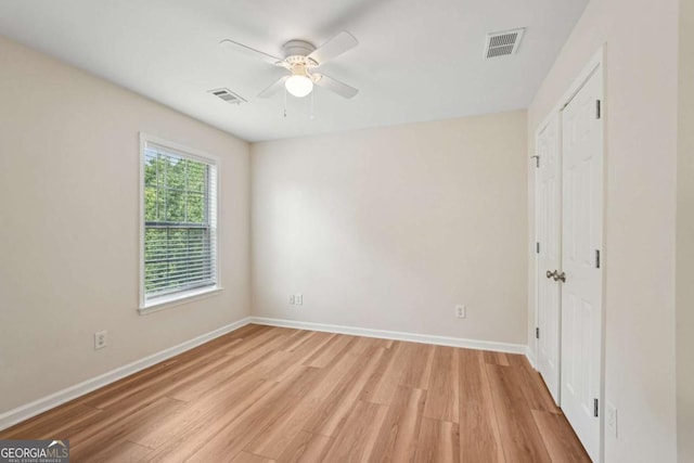 153 Towey Trl, Woodstock, GA 30188 - unfurnished bedroom featuring light wood-type flooring, baseboards, a closet, and ceiling fan