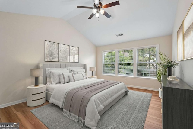 153 Towey Trl, Woodstock, GA 30188 - bedroom with lofted ceiling, baseboards, light wood-type flooring, and ceiling fan
