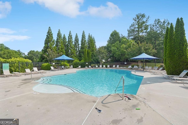 153 Towey Trl, Woodstock, GA 30188 - community pool with a patio area and view of wooded area