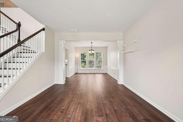 153 Towey Trl, Woodstock, GA 30188 - unfurnished living room with wood-type flooring, stairway, and a wainscoted wall
