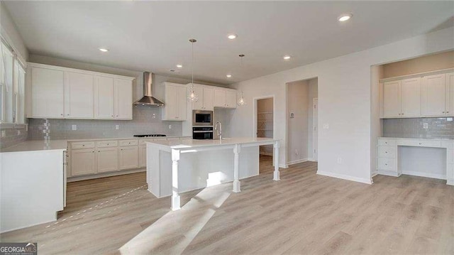308 Delta Dr, Mcdonough, GA 30253 - kitchen featuring wall chimney exhaust hood, stainless steel microwave, backsplash, oven, and light countertops