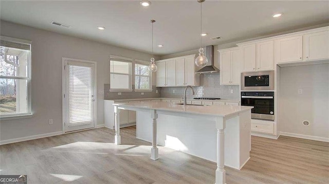 308 Delta Dr, Mcdonough, GA 30253 - kitchen with wall chimney exhaust hood, light countertops, white cabinetry, decorative backsplash, and recessed lighting