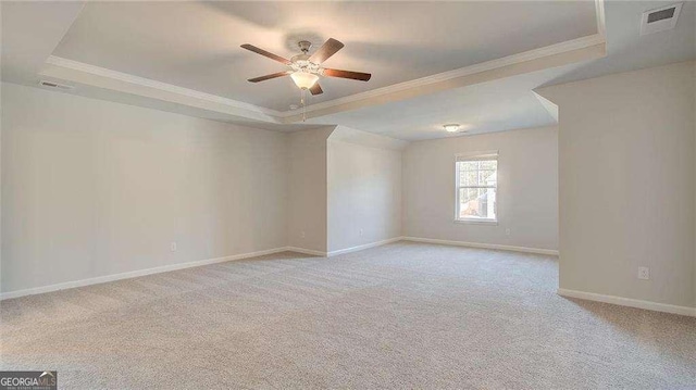308 Delta Dr, Mcdonough, GA 30253 - unfurnished room featuring crown molding, a raised ceiling, ceiling fan, and carpet flooring