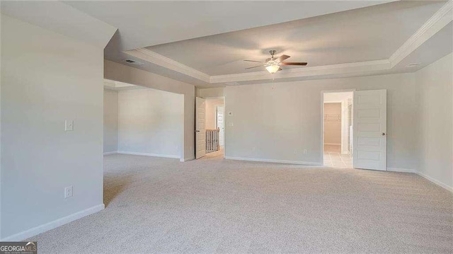 308 Delta Dr, Mcdonough, GA 30253 - empty room featuring a tray ceiling, ornamental molding, a ceiling fan, and light colored carpet