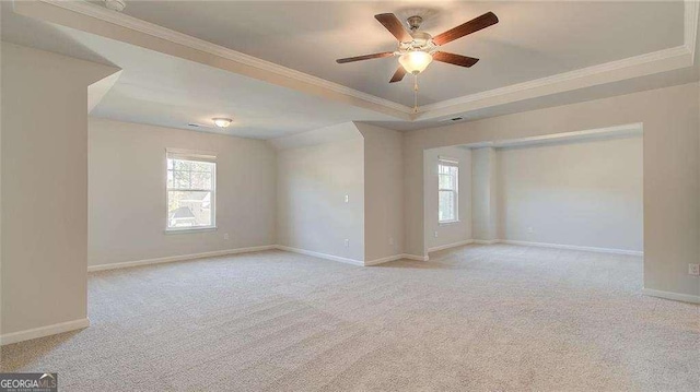 308 Delta Dr, Mcdonough, GA 30253 - unfurnished room featuring a tray ceiling, a ceiling fan, healthy amount of natural light, light carpet, and crown molding